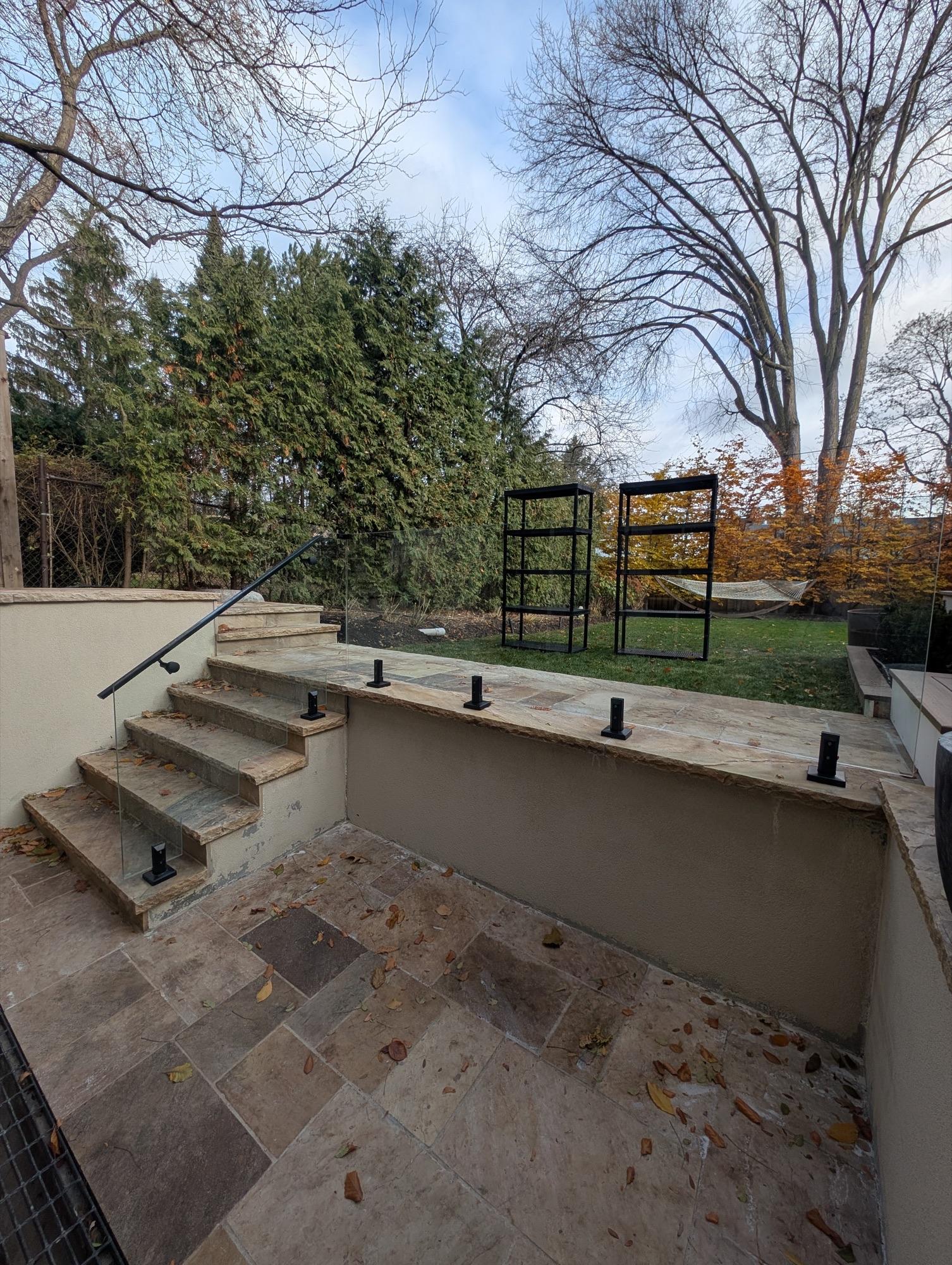 Seamless glass railing integration with custom stone steps