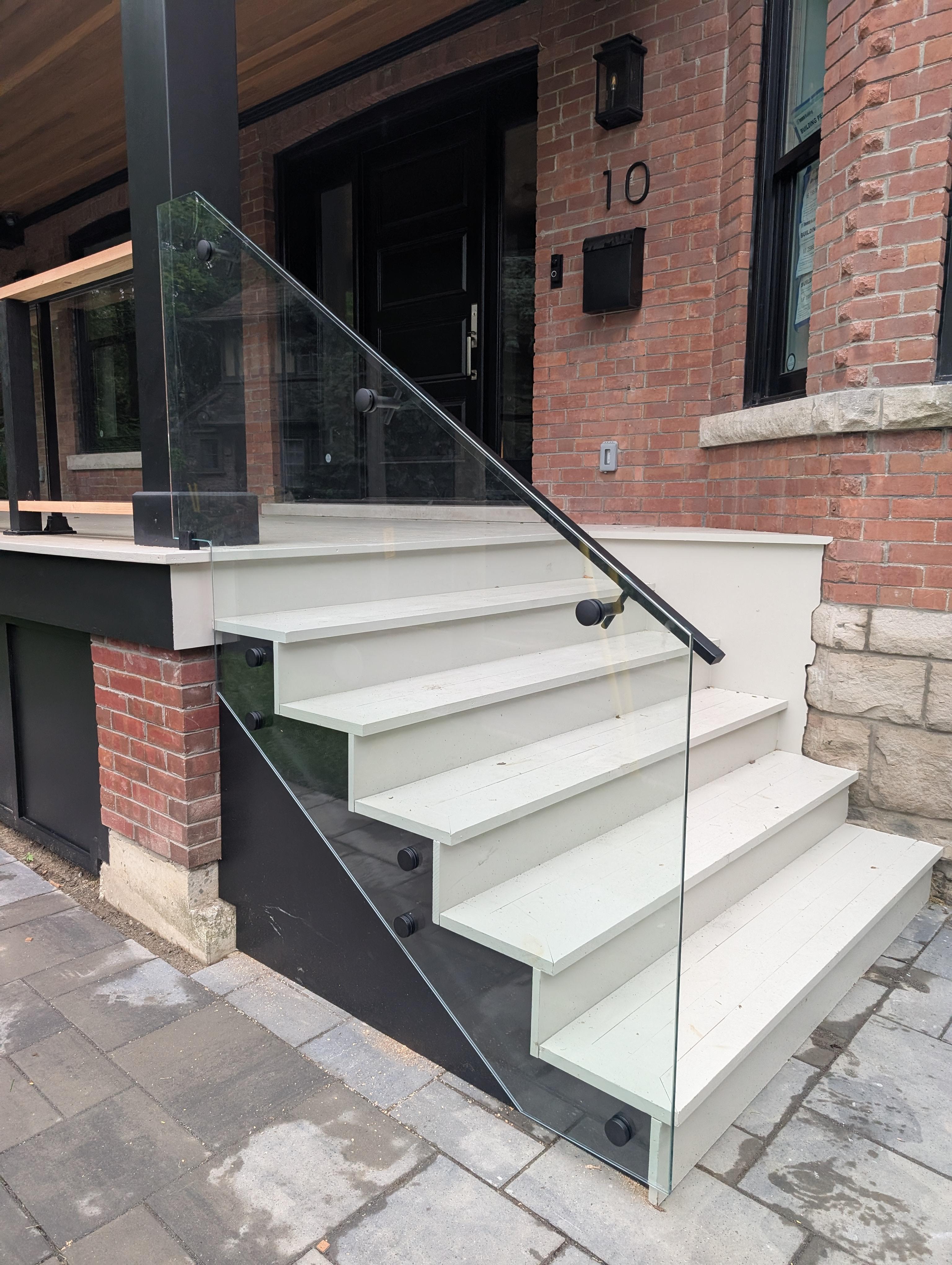 Frameless glass railing on floating wood staircase in Rosedale Toronto