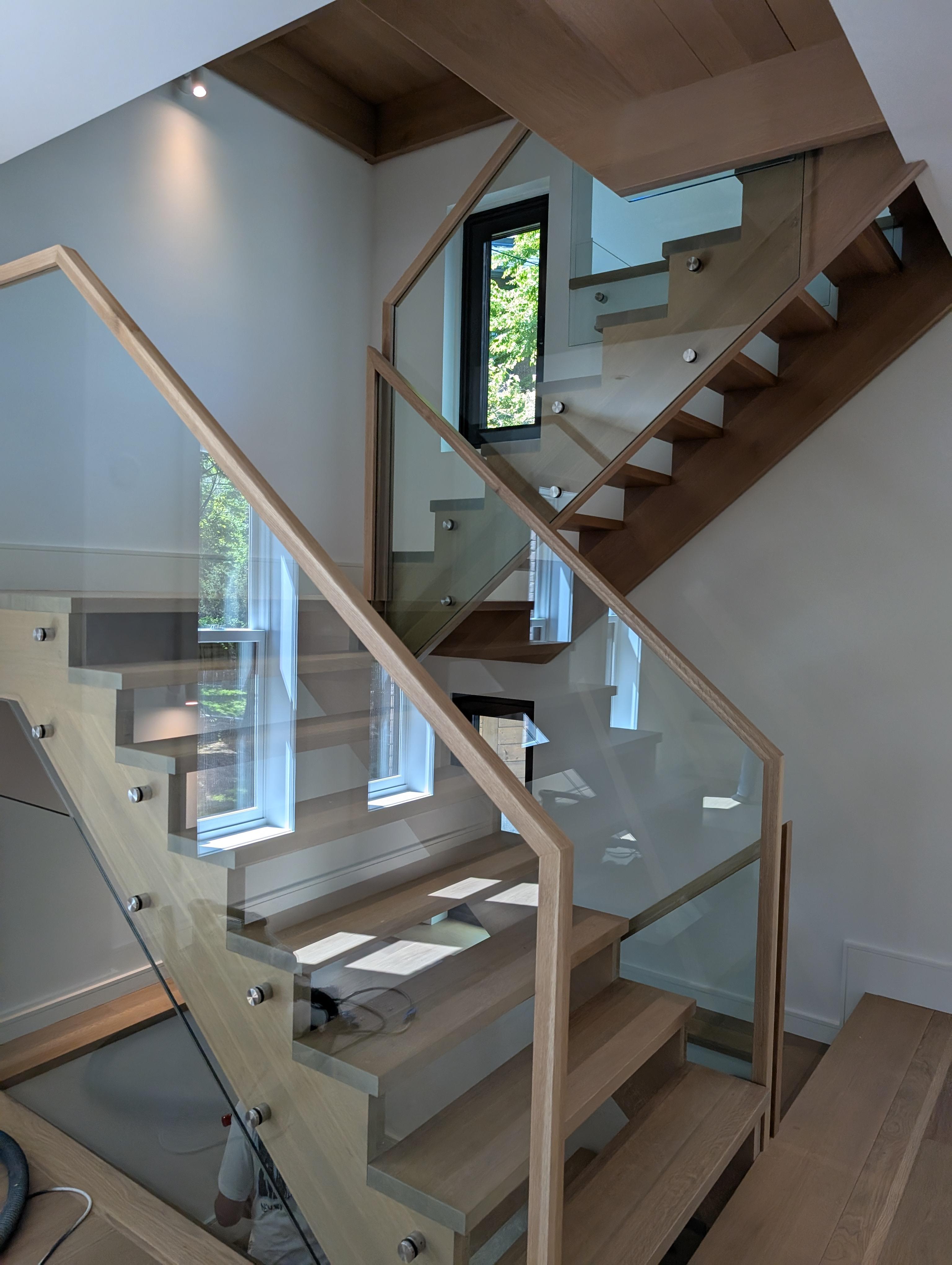 Custom glass guardrail system for stairs and landings